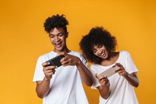 Image Of African American Couple Playing Online Game On Smartphones