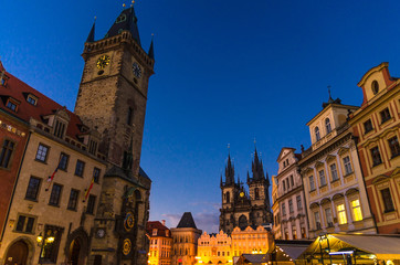 Fototapeta na wymiar Prague Old Town Square (Stare Mesto) historical city centre. Astronomical Clock (Orloj) and Tower of City Hall building, Gothic Church of Our Lady before Tyn, evening view, Bohemia, Czech Republic