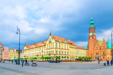 Old Town Hall and New City Hall building, row of colorful traditional buildings with multicolored facades on cobblestone Rynek Market Square in old town historical city centre of Wroclaw, Poland