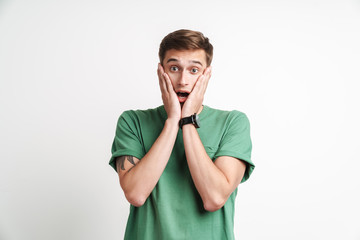 Image of shocked caucasian man being stressed and grabbing his face