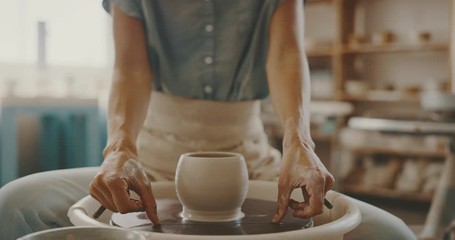 Young artist in pottery studio finishing clay bowl, handmade ceramics, creative artistry