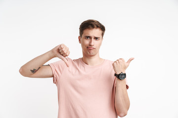 Image of caucasian man showing thumb down and pointing finger aside