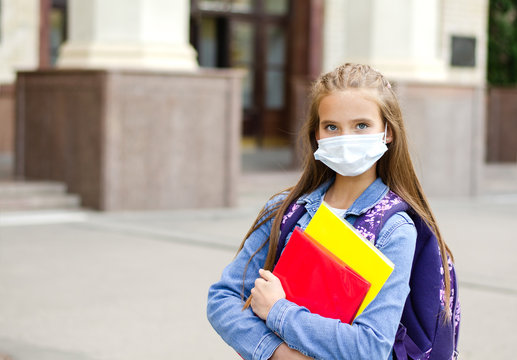 Little Girl Child With Face Mask And Backpack. Education Concept. Back To School After Covid-19.