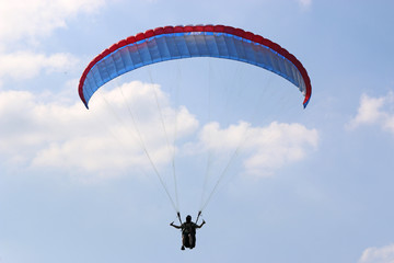Paraglider flying wing in a blue sky	