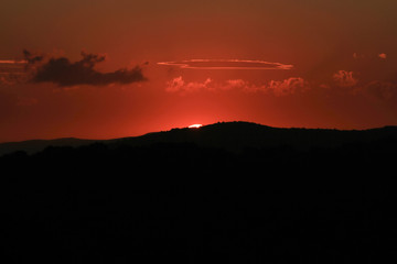 Fototapeta na wymiar Tuscan landscape at sunset, last lights of the day.