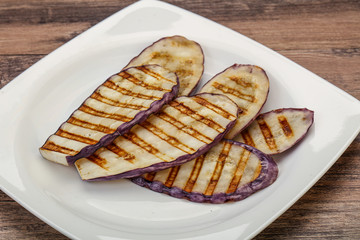 Grilled graffiti eggpant slices with oil
