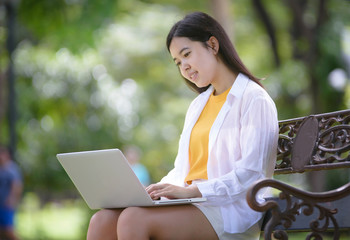 Business women relax and work in the park on vacation