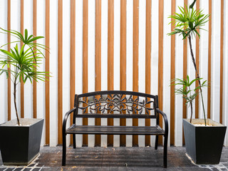 An outdoor bench in front of a strip wall