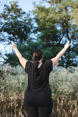 Body positive, freedom, high self esteem, confidence, happiness, obesity. Overweight woman rising...