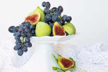 Plate with grapes and raw figs, healthy vegetarian food