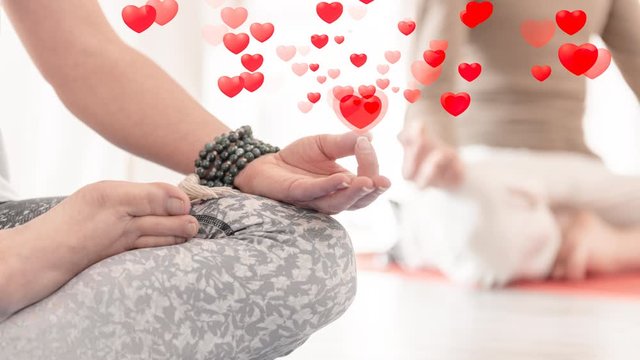 Closeup of female hand in gesture of Chin Mudra or Jnana Mudra and crossed legs in lotto position during meditation. Animated pattern, seamless. Clipart of hearts. Animated cartoon. 4K GIF