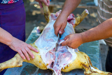 Cutting a pork carcass at home. Cutting a pig into parts.