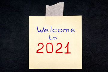 Note with words Welcome to 2021 on blackboard.