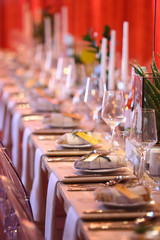 table setting in a room with red lighting for an event.