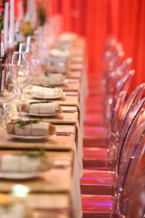 table setting in a room with red lighting for an event.