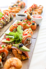 Fresh colorful sushi on a wooden platter.