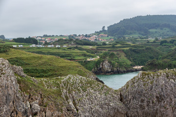 Views of the town of Prellezo in Cantabria from the coast with the mountains in between