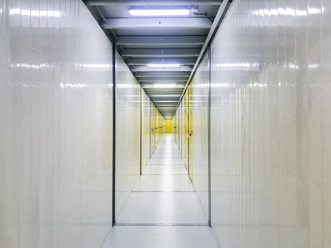 White corridor with yellow doors: storage sections