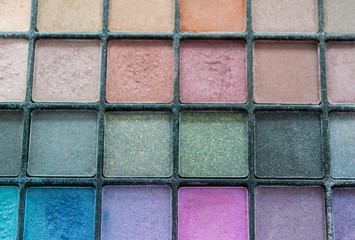 Close up palette with multi colored eye shadow. Makeup nude color, blue, turquoise and pink