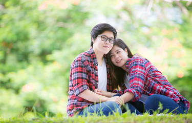 Fototapeta premium Young women are having fun on the green field in the morning.,LGBTQ Lesbian Couple