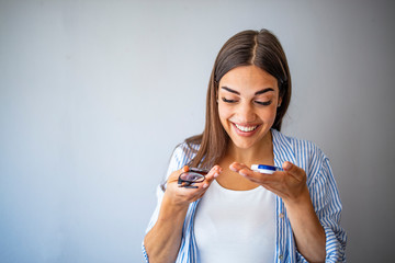 Woman choosing between eyeglasses and contact lenses. Lifestyle. Myopia and eyesight problem...