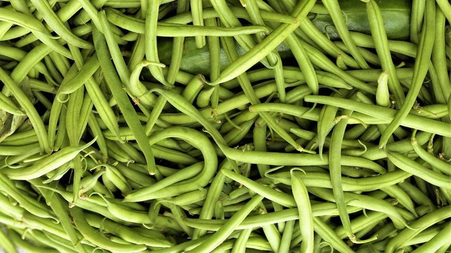 Seamless image of green, raw French Beans kept in a market for sale.