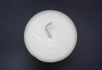 Closeup photo from above of a white wax candle