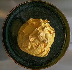 TikTok cloud bread. Whipped egg whites on a black plate. Baked meringue on a plate. Meringue dessert 