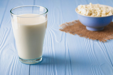 Glass of milk with bowl of cottage cheese