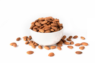 Almonds in a white bowl on a white background. Best healthy food almond concept