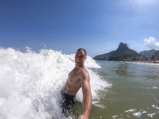 Young man swimming in Ipanema, Rio de Janeiro