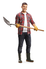 Male gardener in boots holding a shovel