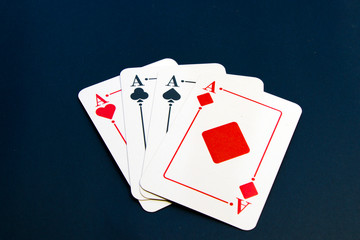 Four aces and chips, card game, cards on the table. Poker and blackjack.