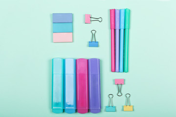 Back to school shopping concept. Pastel colored school supplies on paper background. Flat lay, top view, copy space.
