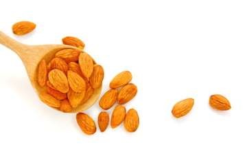 group of brown almond seed high vitamin on wooden spoon isolate on white background.