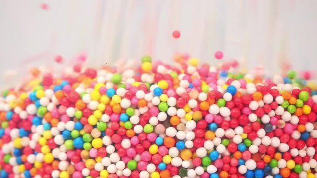 Sweet candy many&nbsp;colors drop into clear cups, Food concept.