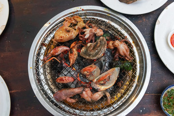 Fresh seafood cooking on the table gril