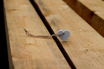 Heart shaped pendant on wooden beams.