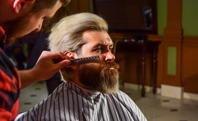 Man at barbershop. Hairdresser salon. Professional barber and client. Trimming beard close up. Maintaining beard shape. Enhance your hair cutting experience. Facial hair. Grow beard and mustache