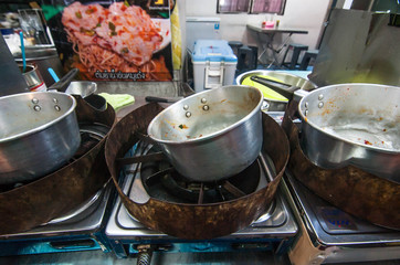 The dirty pots at street food Tomyum ramen noodle truck at Talat Phlu outdoor market in Bangkok Thailand 