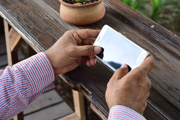 Working men closely watch videos on their mobile phones during the day, with free copy space for ad text or promotional content.