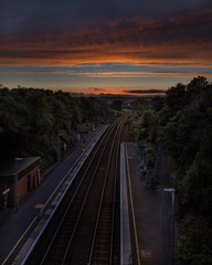 Sunset on Liskeard rail station tracks Cornwall, blue and orange sky