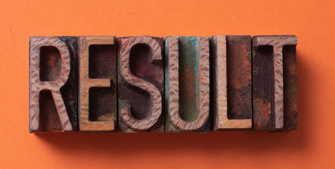 Result word written with wood type blocks