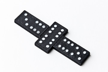 The domino board game. Black chips. White background