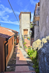 Fototapeta premium A narrow street among the old houses of Maierà, a rural village in the Calabria region.