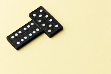 Domino board game. Black chips. Yellow background