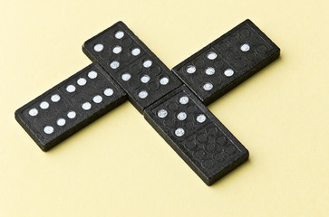 Domino board game. Black chips. Yellow background