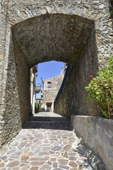 Fototapeta na wymiar A narrow street among the old houses of Maierà, a rural village in the Calabria region.