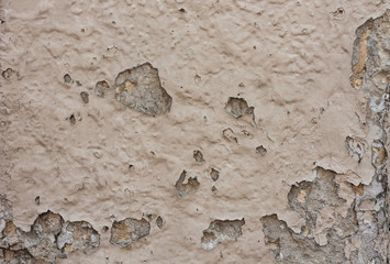 texture of a stone wall of an old building with crumbling plaster, ancient architectureю