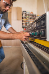 Carpenter adjusting wood processing machine